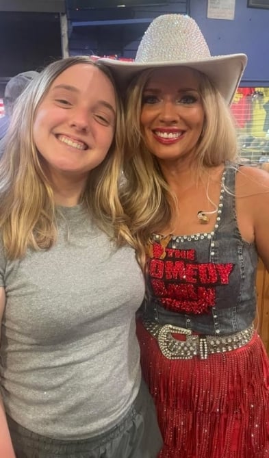 A guest taking a selfie with the singer from the band.