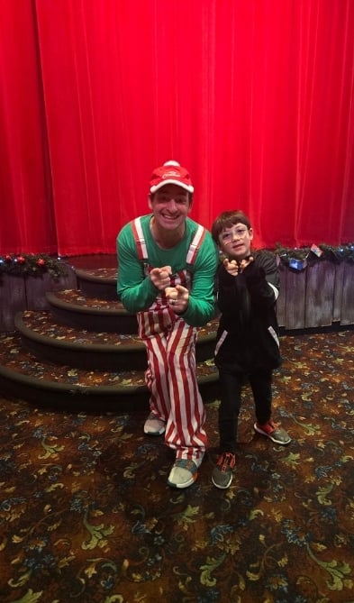 A young boy with the comedian at the Comedy Barn show.