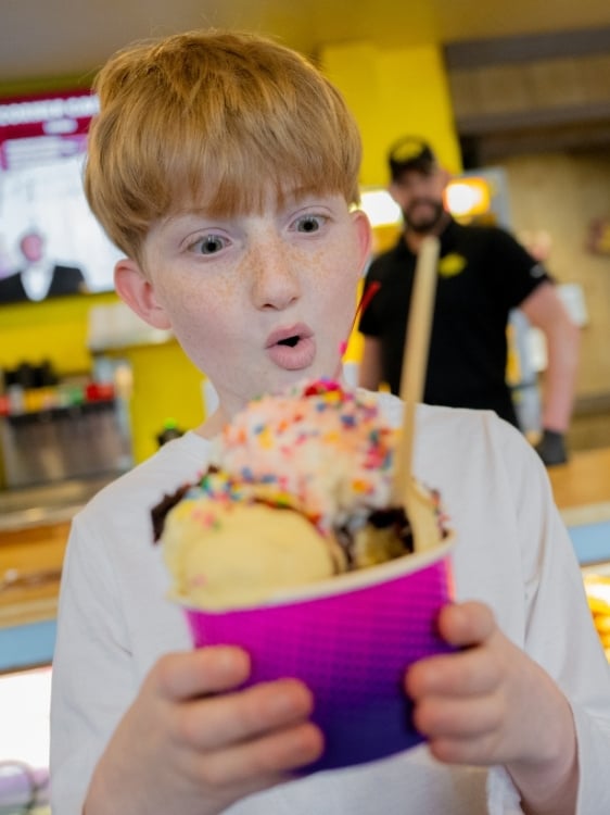 A guest and the ice cream sundae at the Comedy Barn.
