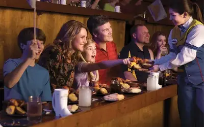 family eating the feast at Dolly Parton's Stampede