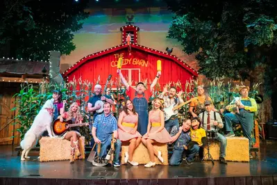 Cast of the Comedy Barn on stage